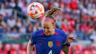 USWNT captain Becky Sauerbrunn head the ball in blue kit ahead of the Concacaf W Gold Cup women's soccer tournament 2024