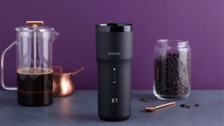 Ember Travel Mug 2+ on a countertop with a coffee press and a jar of coffee beans