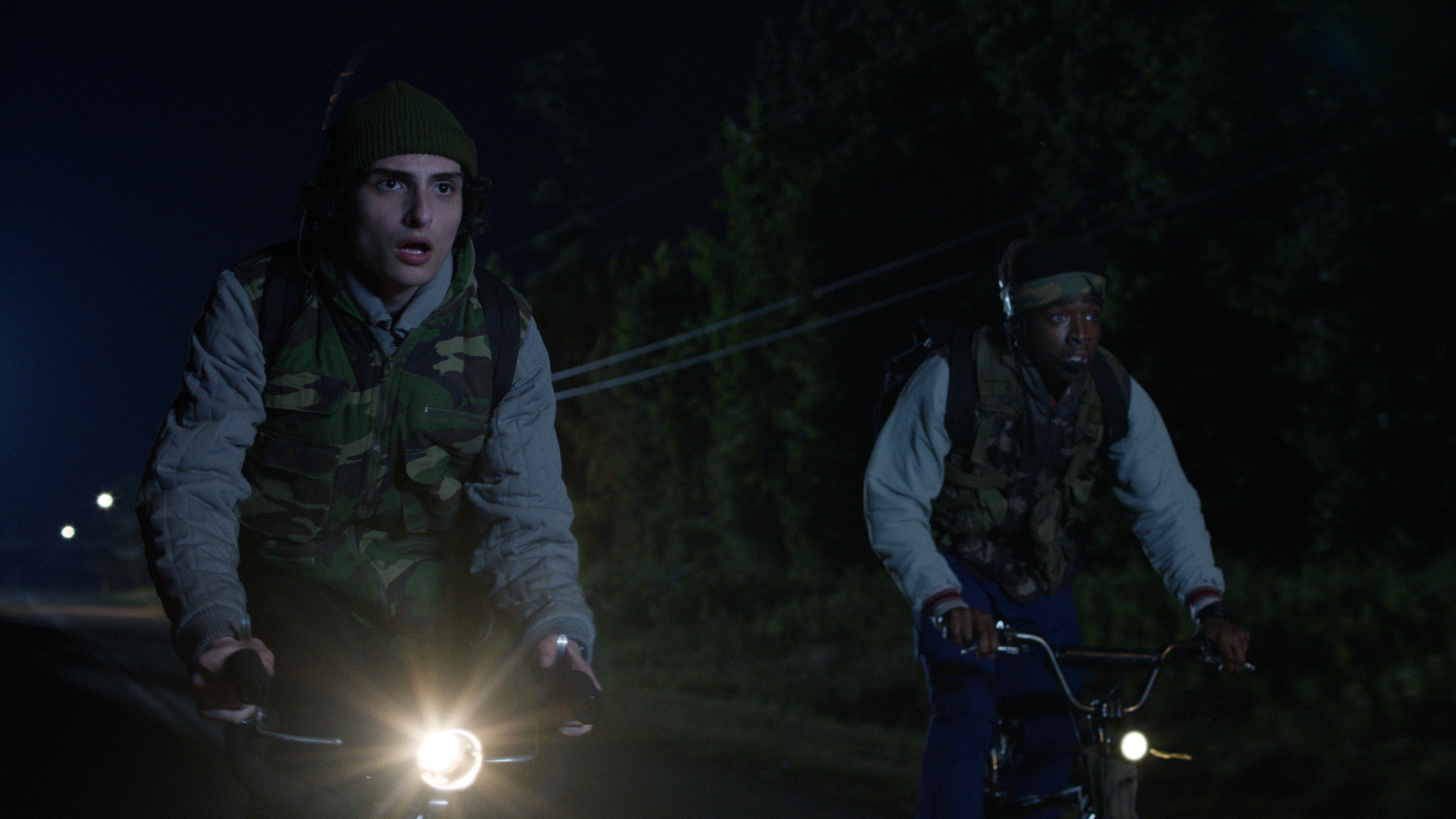 Mike (Finn Wolfhard) and Lucas (Caleb McLaughlin, L-R) ride their bikes at night in a scene from the "Stranger Things" season 5 trailer