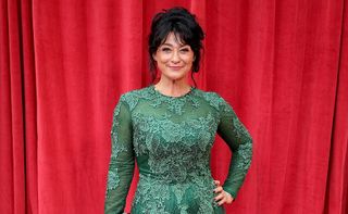 Natalie J. Robb on the red carpet for the British Soap Awards 2018 wearing a green lacy dress 