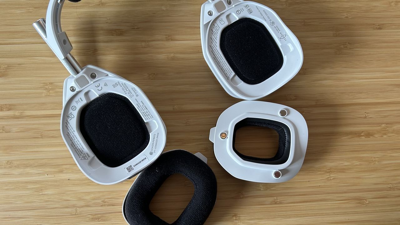 Astro A50 X headset with padding removed and placed to the side on a wooden desk
