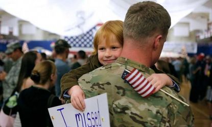 A child hugs his father who returned from Afghanistan on Nov. 4, 2012, after a nine-month deployment.