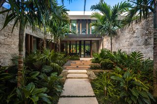 Garden path surrounded by foliage at the Tarpon Bend Residence