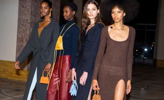 Models wear turtle-neck sweaters, trench coats and chunky knitwear in dark blue, browns and reds