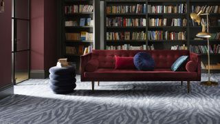 carpet in plush living room with built-in bookcases