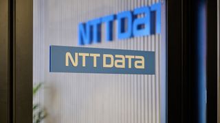 NTT Data logo displayed on a glass door in an office