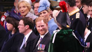 Prince Harry, Duke of Sussex speaks to Princess Anne, Princess Royal during the Coronation of King Charles III and Queen Camilla