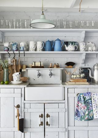 Open kitchen shelving used to display glassware and colourful jugs