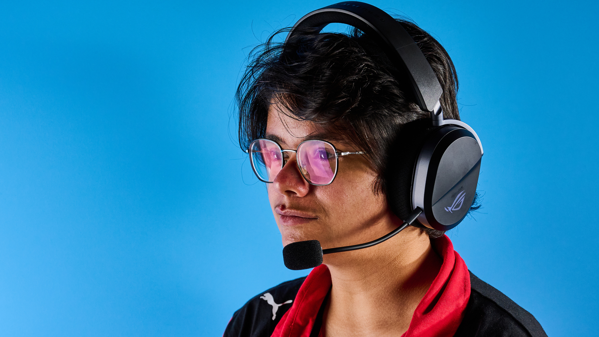A black Asus ROG Pelta gaming headset with a detachable mic and RGB lighting
