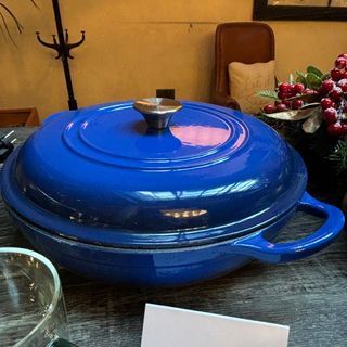 Blue cast iron casserole dish on table