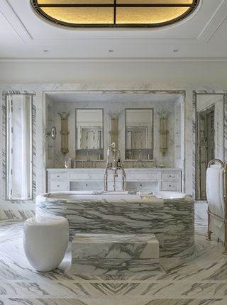marble bathroom with rounded marble bath