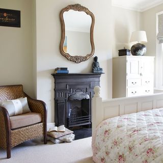 white bedroom with fire place and mirror
