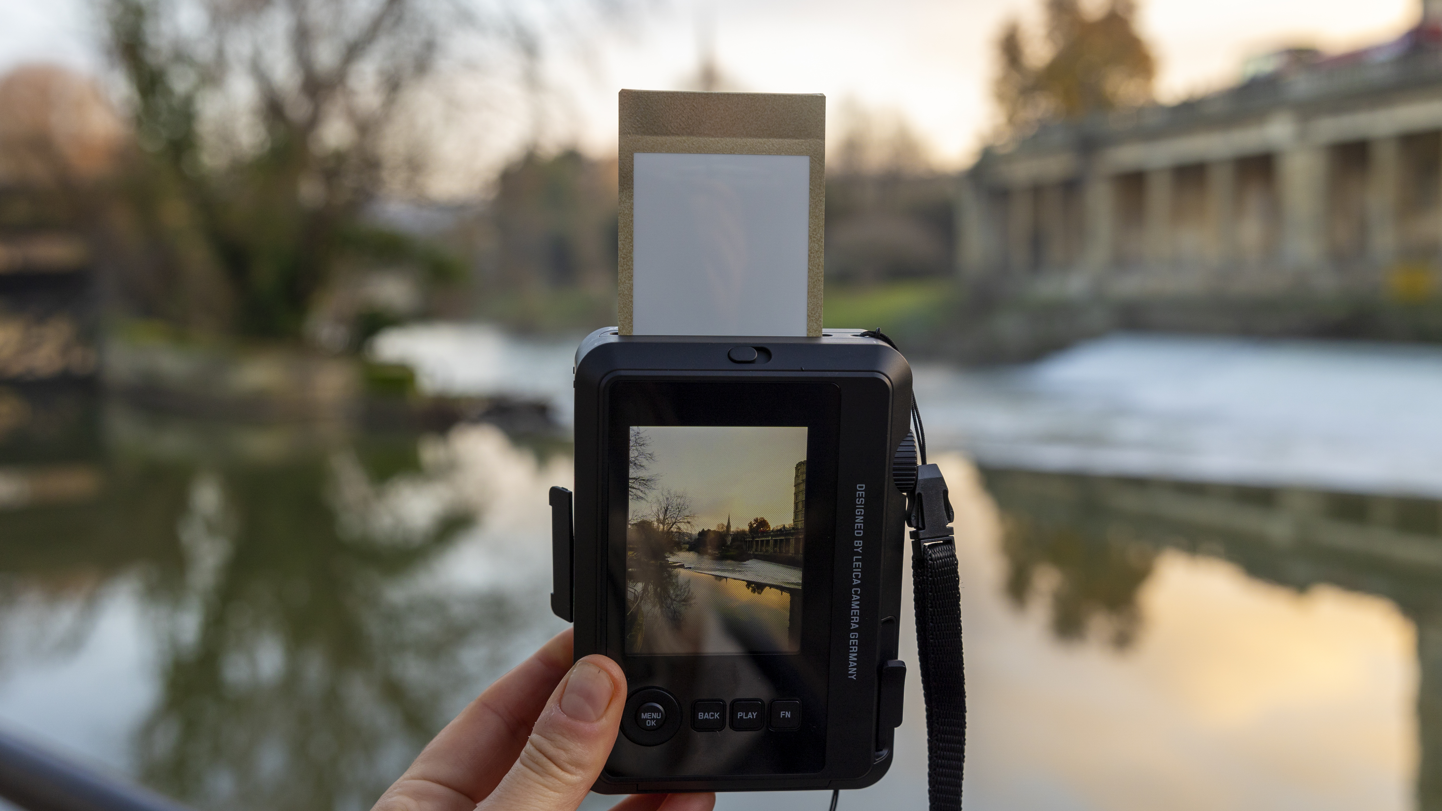 An Instax Mini print coming out of the Leica Sofort 2