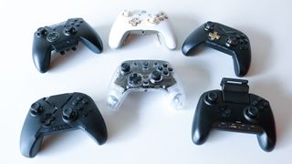 A few pro controllers grouped together on a table