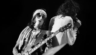 Joe Perry (left) and Steven Tyler of Aerosmith perform onstage at the Boston Garden on December 17, 1974 