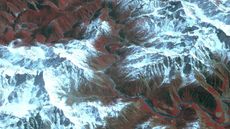 A composite satellite image of the Yarlung Tsangpo River surrounded by mountains.