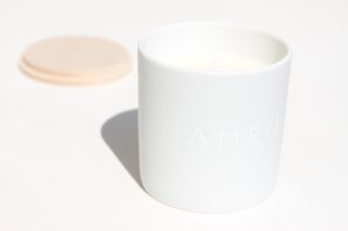 White candle with AMEN written on the outside