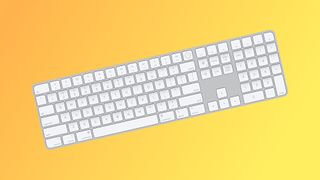 Apple Magic Keyboard with Touch ID and Numeric Keypad on a yellow background