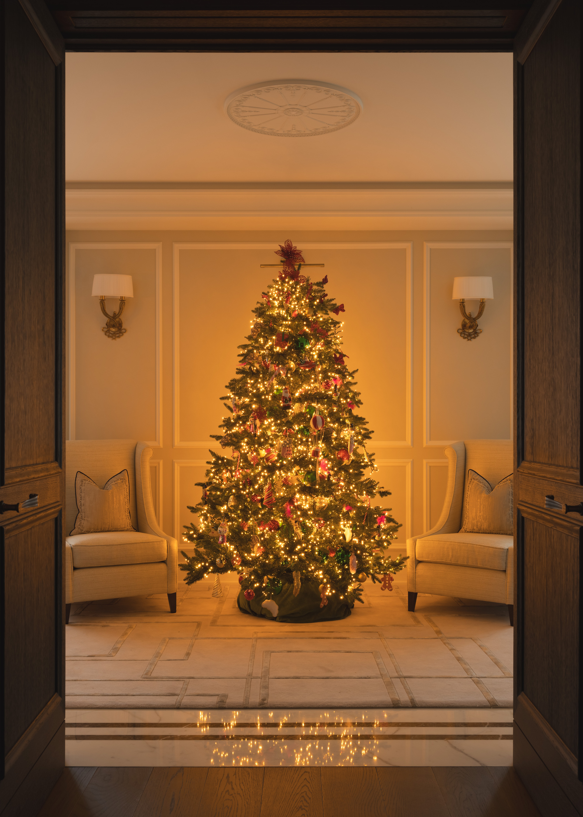 A living room decorated for Christmas with a bright Christmas tree with bright lights