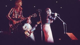 Elton John performs on stage at Nippon Budokan, Tokyo, Japan, 1st February 1974. L-R Davey Johnstone, Dee Murray, Elton John.