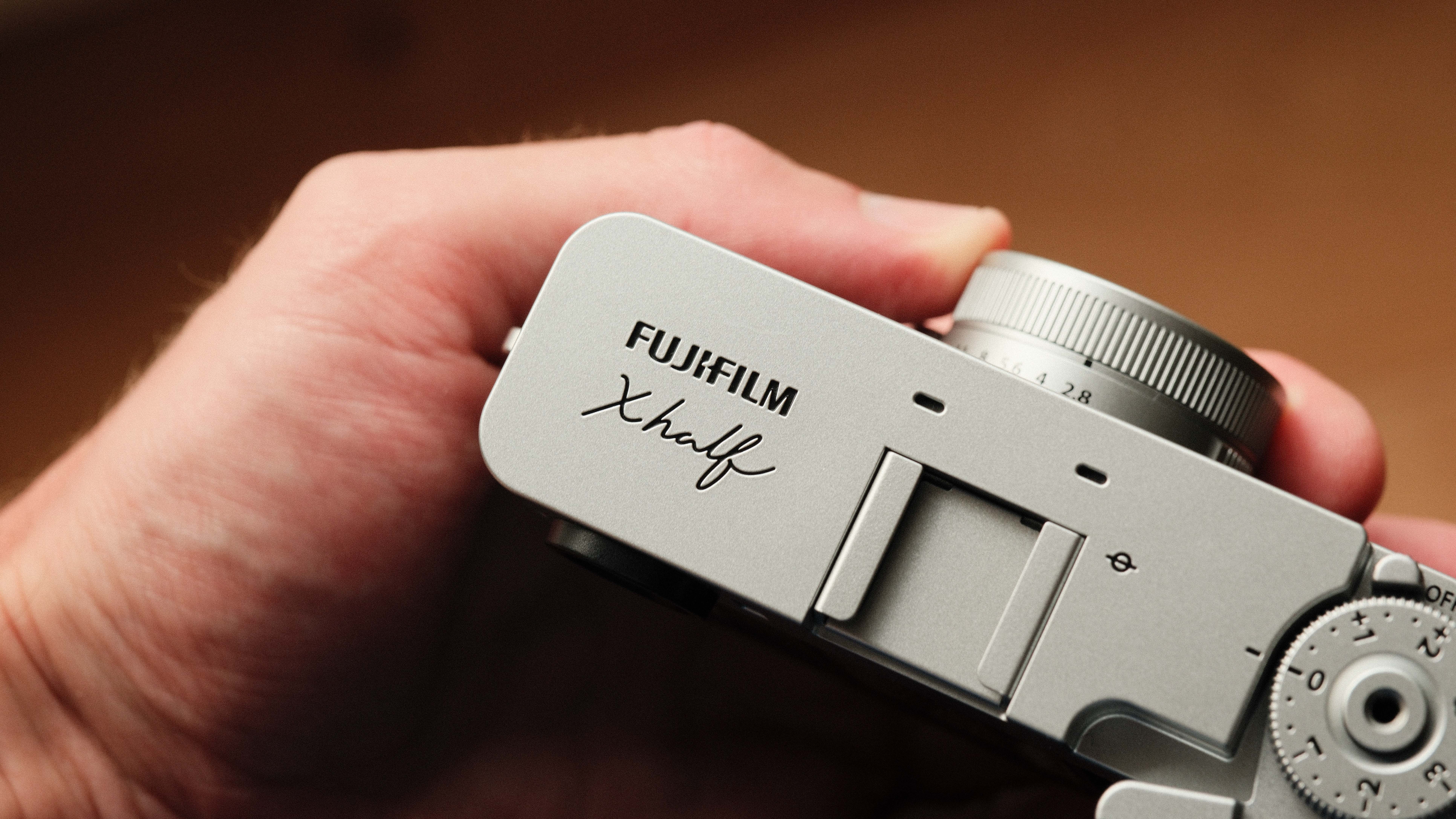 Fujifilm X Half camera held in a hand