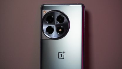 The OnePlus 12R against a pink background