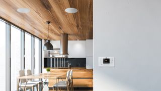 the q acoustics e120 mounted on a kitchen wall