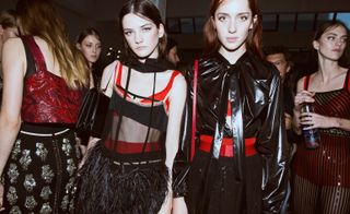 These romantic silhouettes were offset by more sporty shapes, like glossy black windbreakers, buckled belts and diamante encrusted leather hoods.