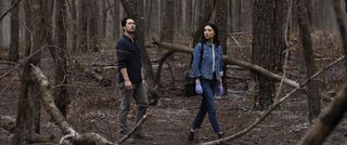Alec Holland and Abby Arcane wander through a rotten forest