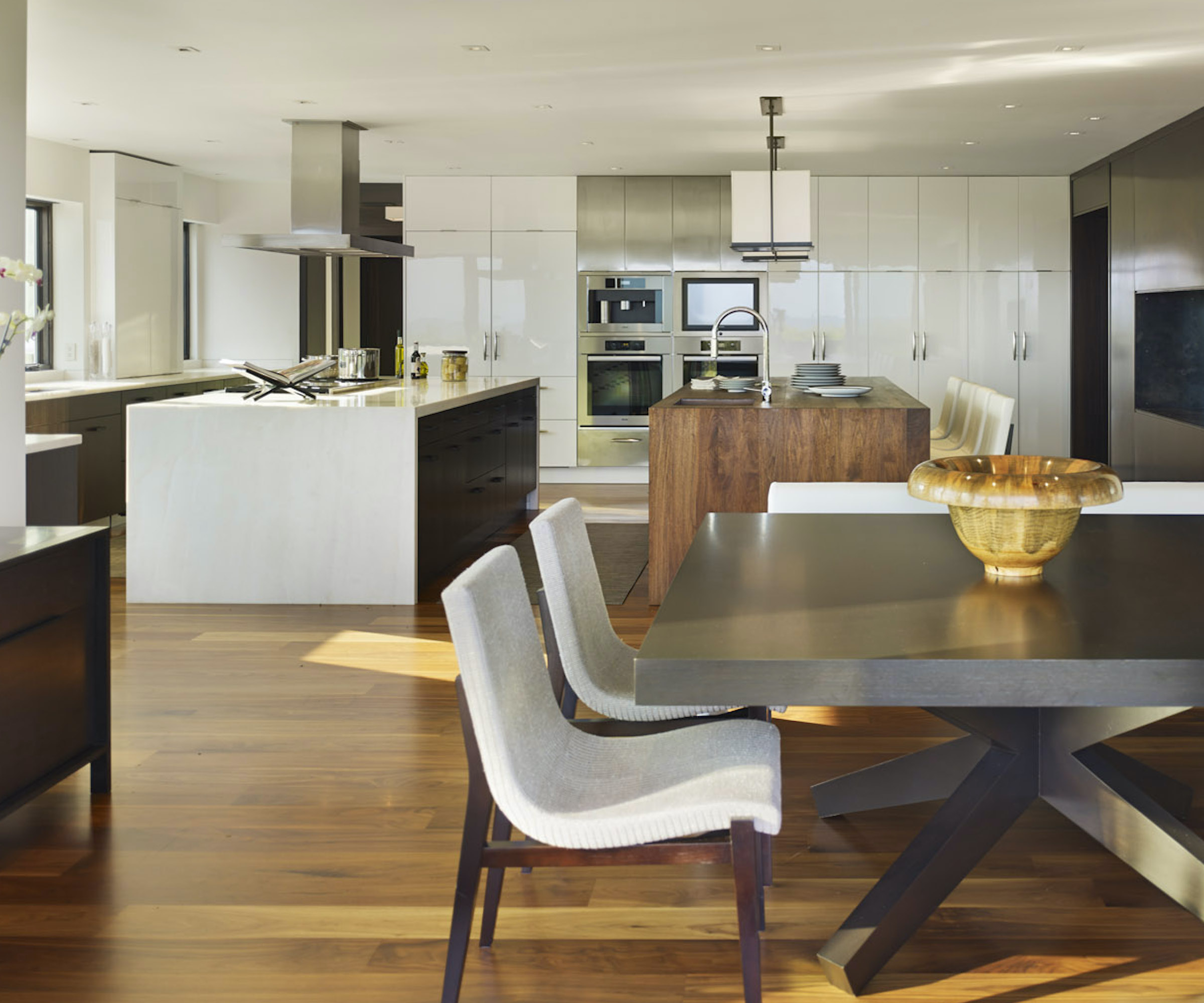 open plan kitchen with two islands and dining table