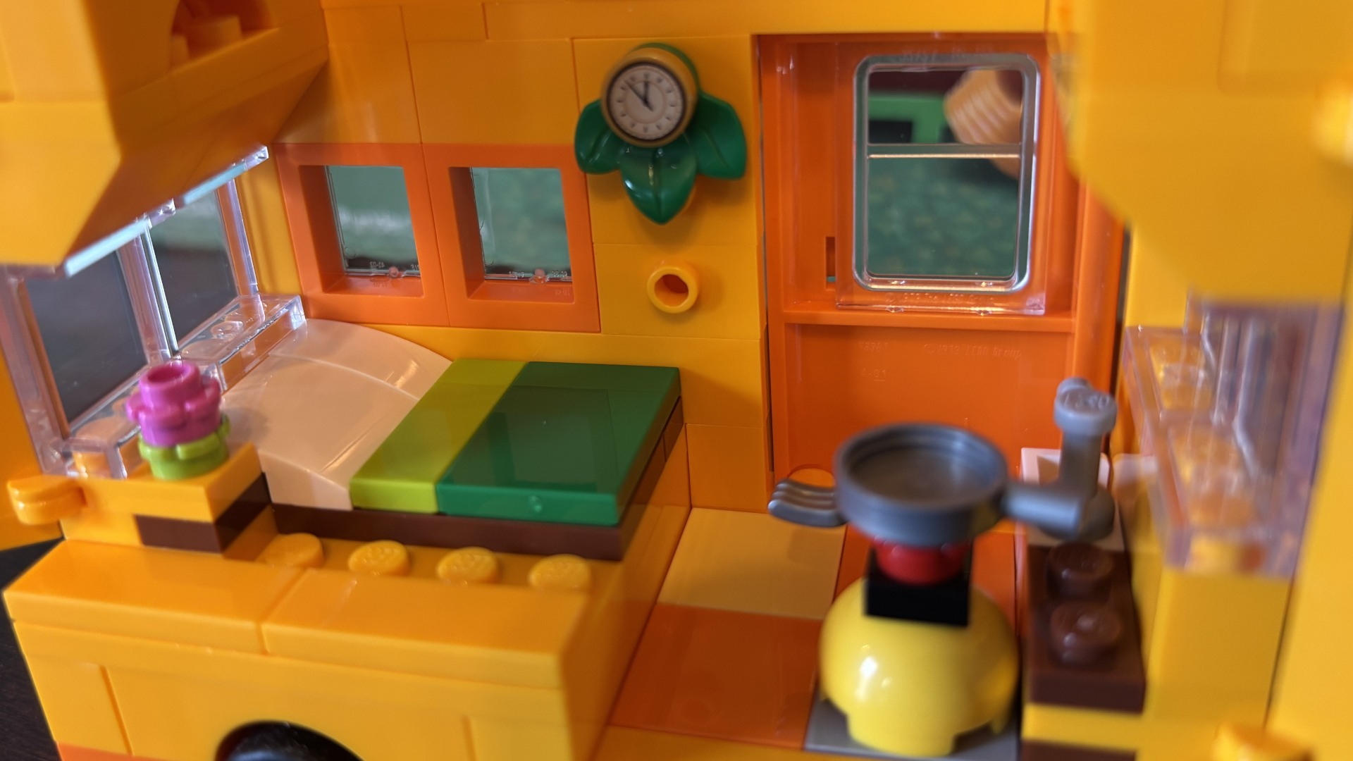 Lego Leif&#039;s Caravan interior, with a bed, clock, and appliances visible