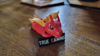 An MSI dragon figurine on a wooden table