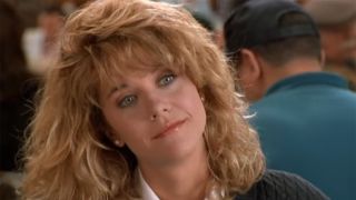 Meg Ryan with teased hair looking at Billy Crystal across the table at the deli in When Harry Met Sally.