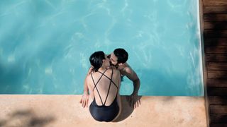 Couple kissing at poolside