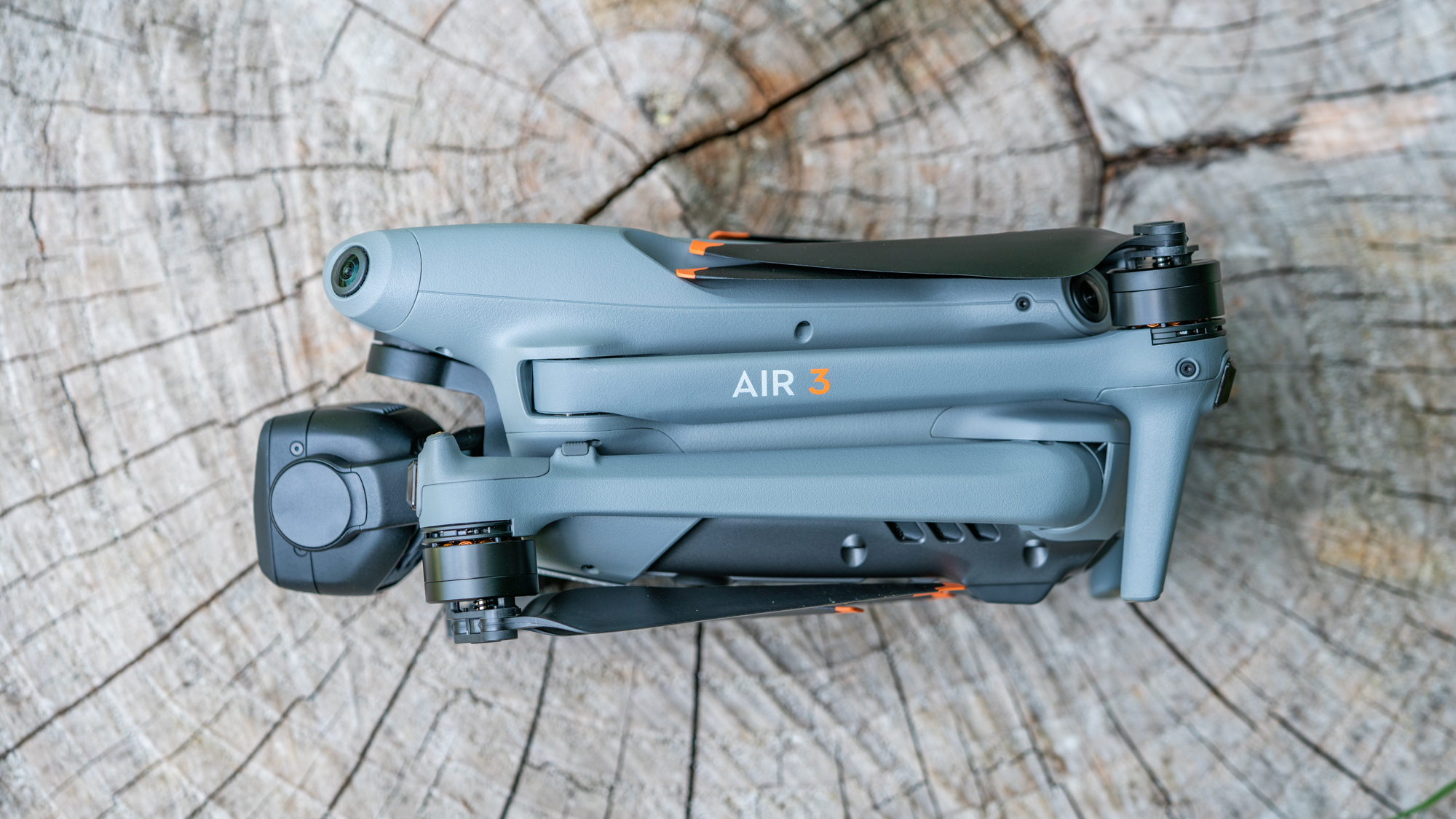 DJI Air 3 drone on a tree stump with arms and propellors folded away