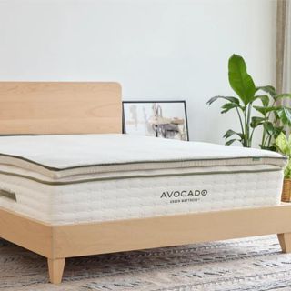 Avocado Organic Latex Mattress Topper on a bed.