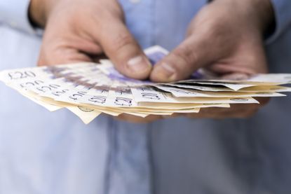 Man holding pound notes