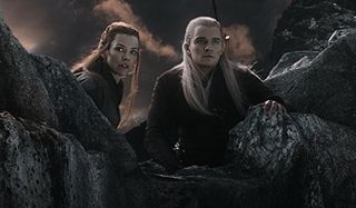 The Hobbit :The Battle of Five Armies Evangeline Lilly and Orlando Bloom spot something on the cliff