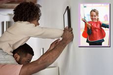 child on fathers shoulders putting picture frame on wall, drop in of girl happy with apint brushes