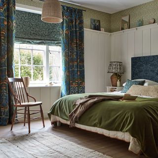 bedroom with velvet blinds and curtains with double bed and green velvet throw