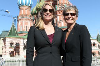 NASA astronauts Kate Rubins and Peggy Whitson pose for a photo with St. Basil's Cathedral in Moscow as a backdrop.