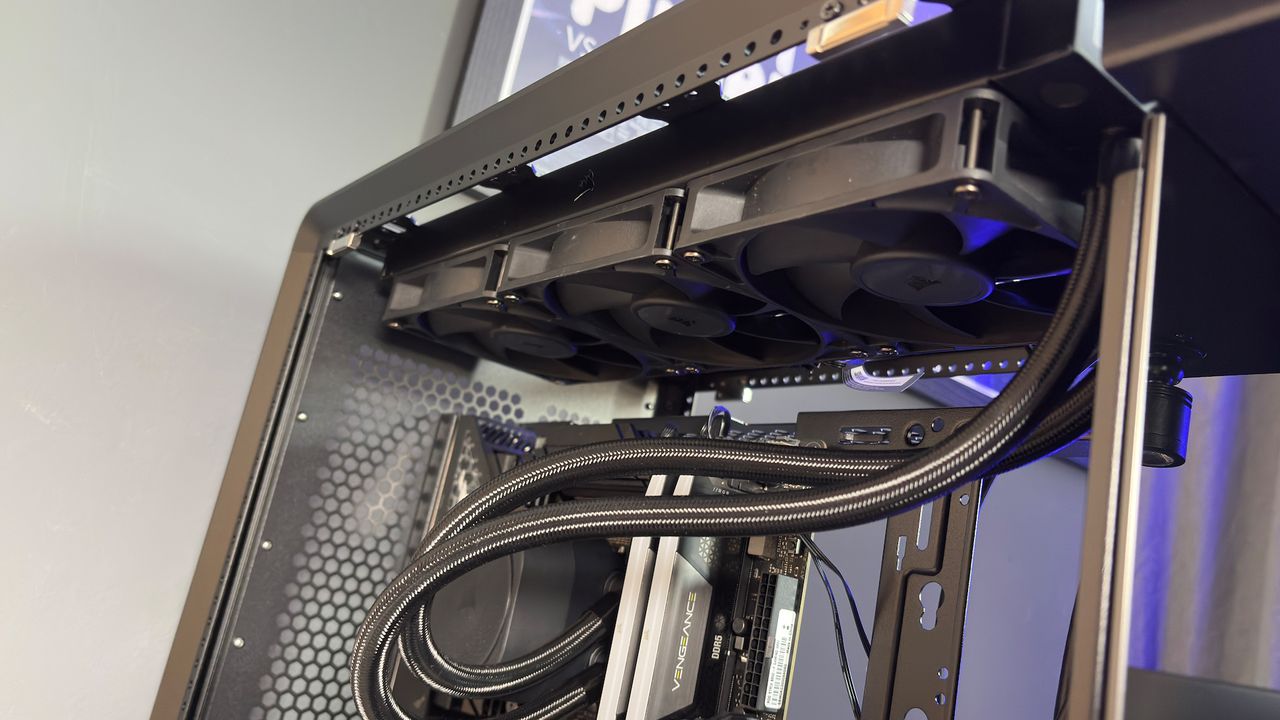 The CoolerMaster MasterFrame 360 Panoramic PC case with various components installed on a desk.