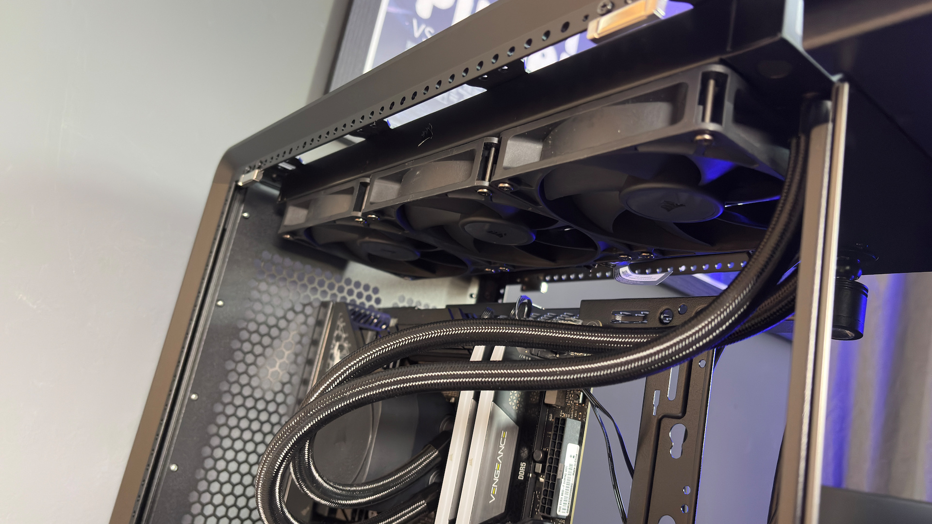 The CoolerMaster MasterFrame 360 Panoramic PC case with various components installed on a desk.