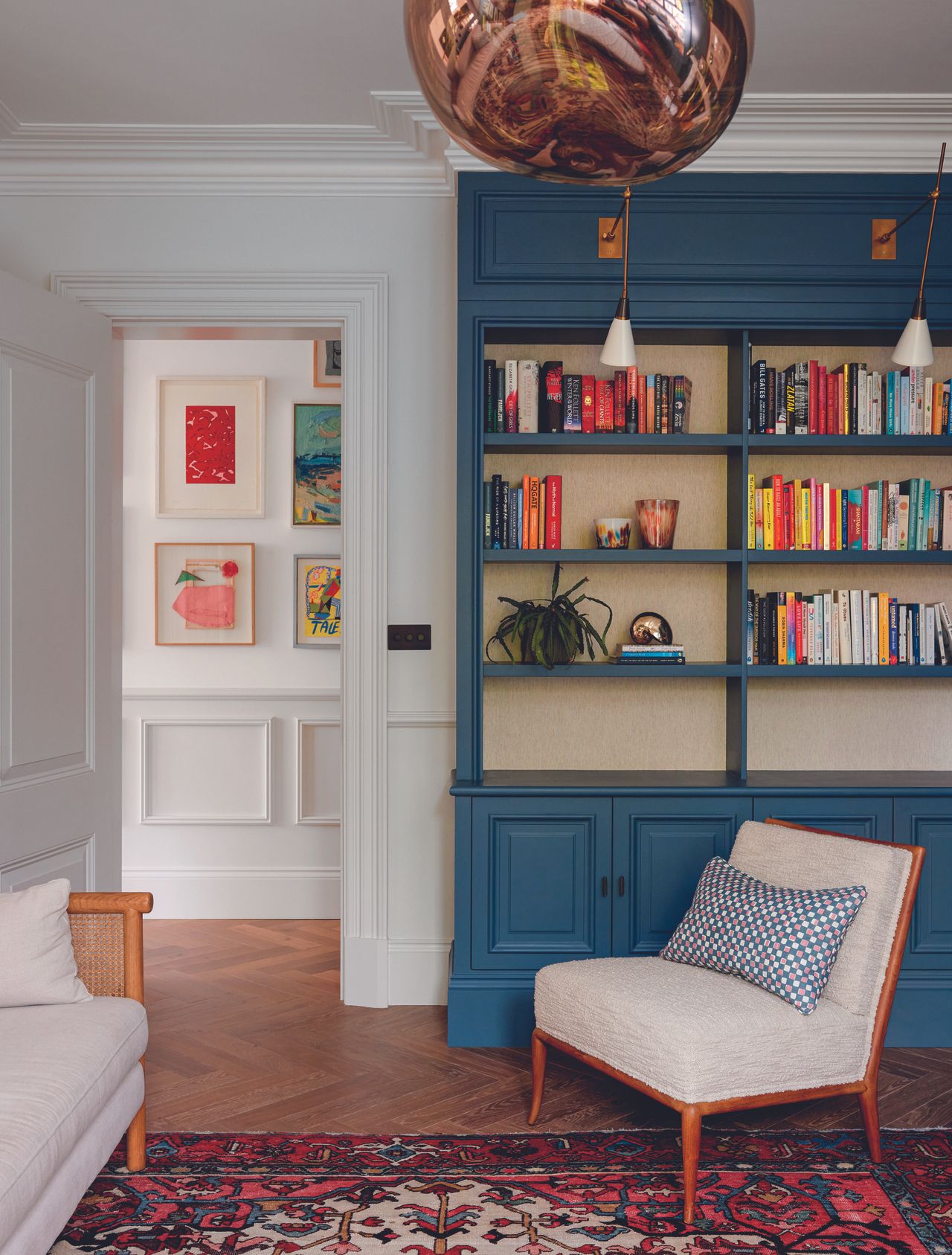 A home library with blue painted shelving