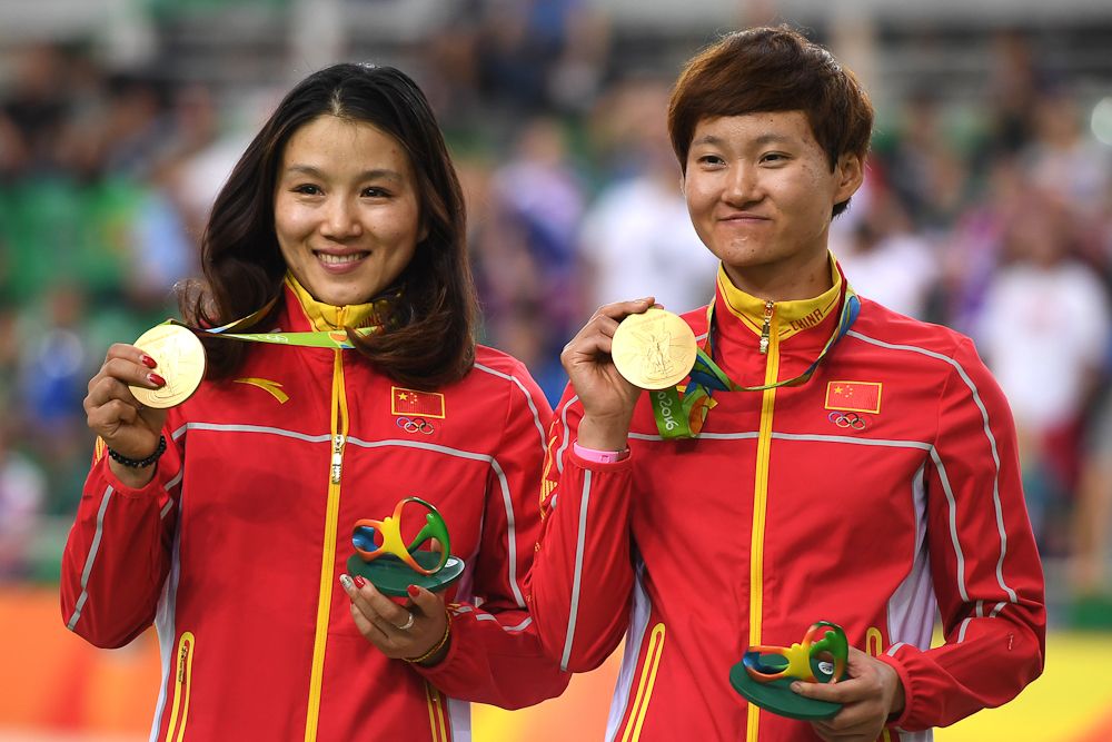 Gold medallists China's Gong Jinjie (L) and China's Zhong Tianshi pose on the podium with their medals after the women's Team Sprint