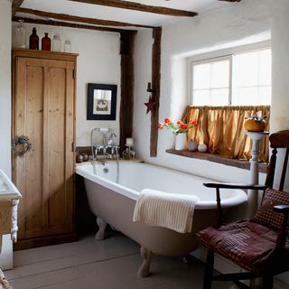 vintage country bathroom with exposed wooden beams