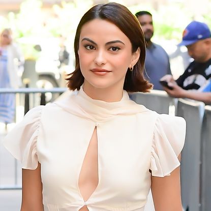 Camila Mendes styled her ivory summer skirt set with a brown east-west bag from DeMellier