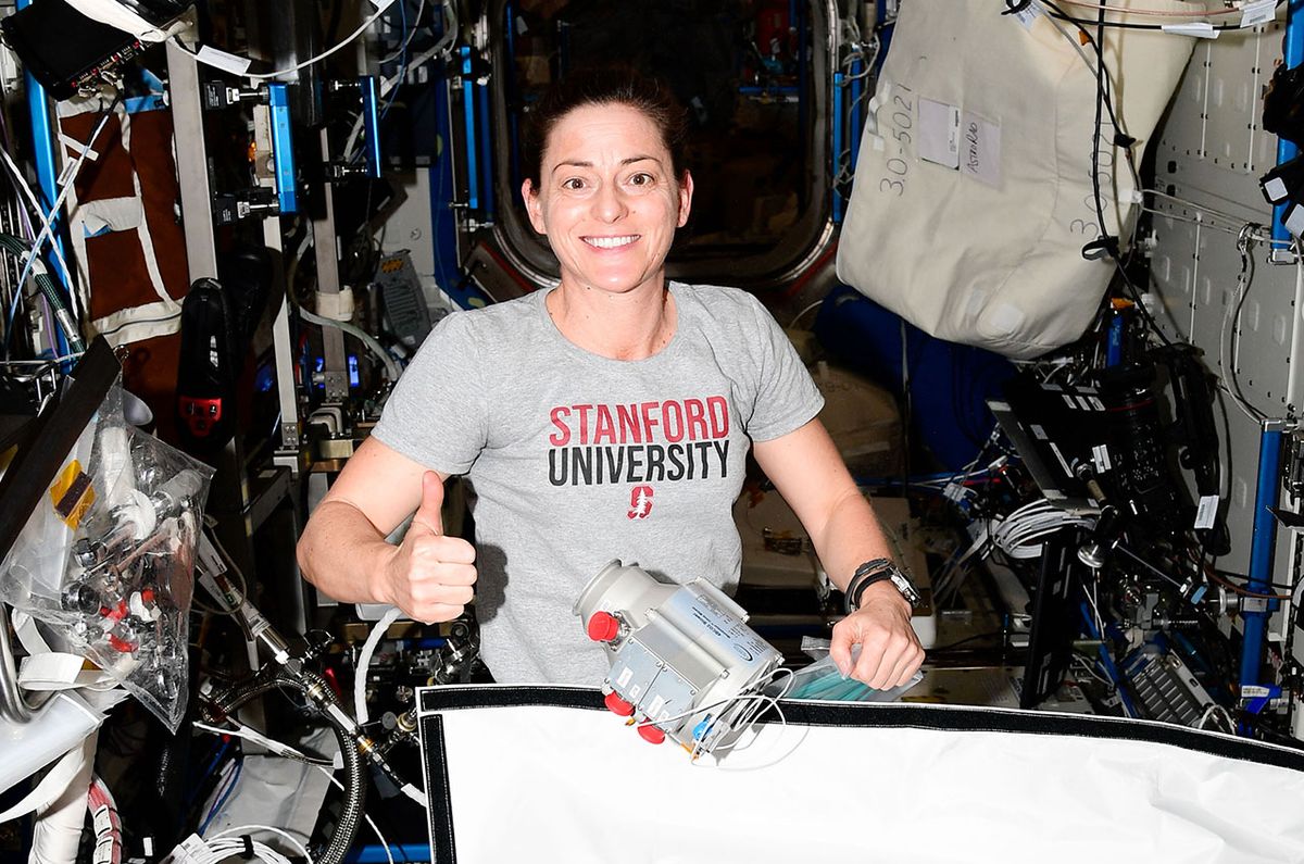 Expedition 68 flight engineer Nicole Mann works on the Four Bed Carbon Dioxide Scrubber (FBCO2), including the installation of Calnetix Technologies&#039; Momentum In-Line Blower (seen floating at center) on the International Space Station, February 2023.