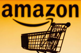 Shopping cart in from of Amazon logo with orange background