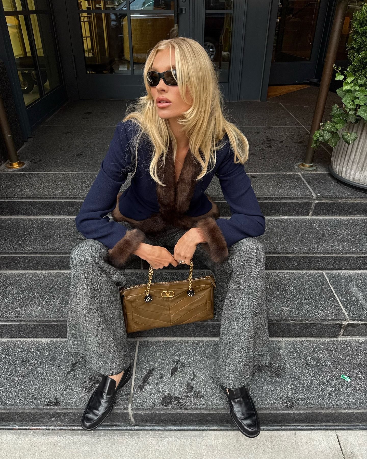 Elsa Hosk wearing a navy jacket and gray pants in NYC
